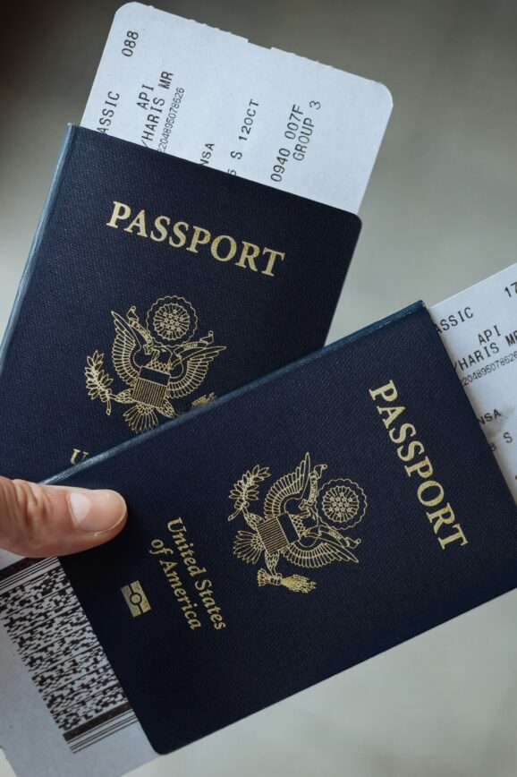 Traveler holding two passports and airline tickets