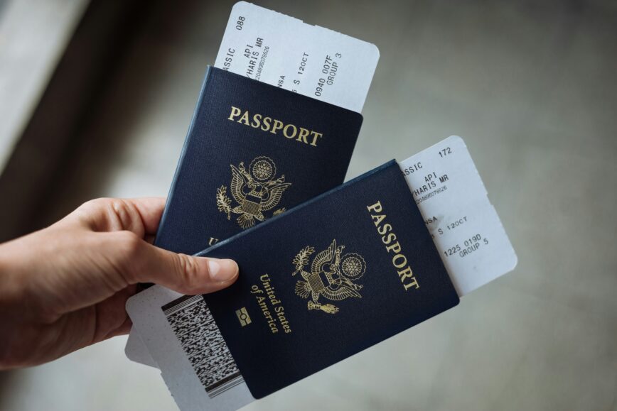Traveler holding two passports and airline tickets