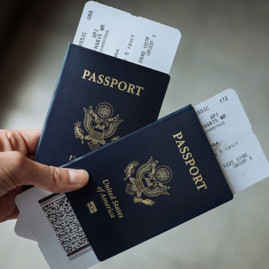 Traveler holding two passports and airline tickets