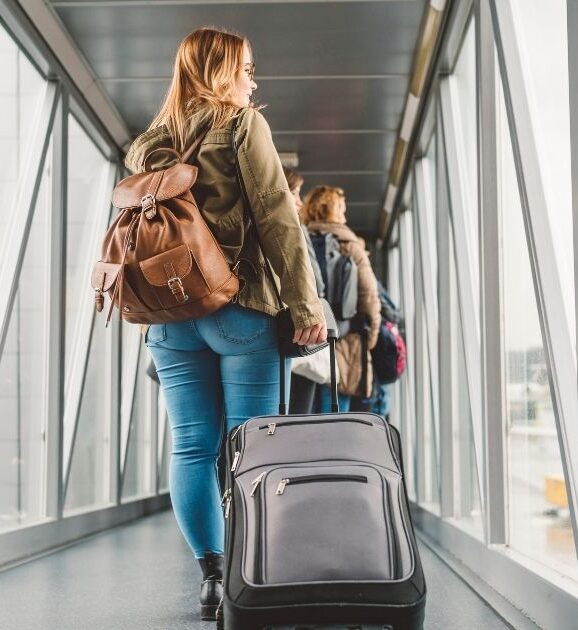 Traveler boarding a plane before an 11:55 a.m. flight