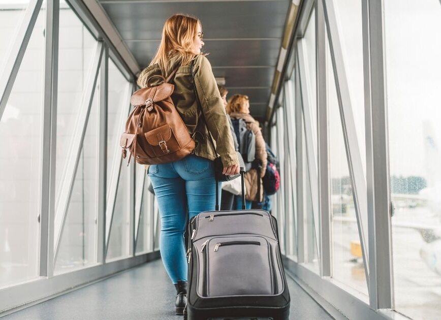 Traveler boarding a plane before an 11:55 a.m. flight